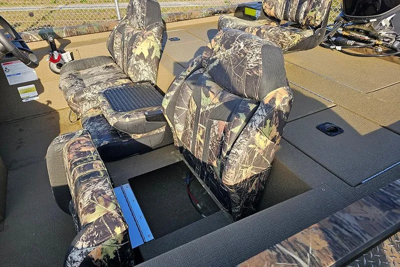 Slide: The Image of 2026 G3 Sportsman 1810 boat interior with camouflage seating and storage compartments. - 12