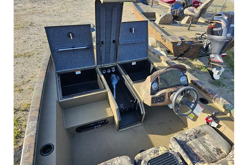 Slide: The Image of 2026 G3 Sportsman 1810 boat interior with open storage compartments and Yamaha outboard motor. - 14