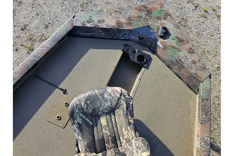 Slide: The Image of 2026 G3 Sportsman 1810 boat interior with camouflage seat and deck. - 16