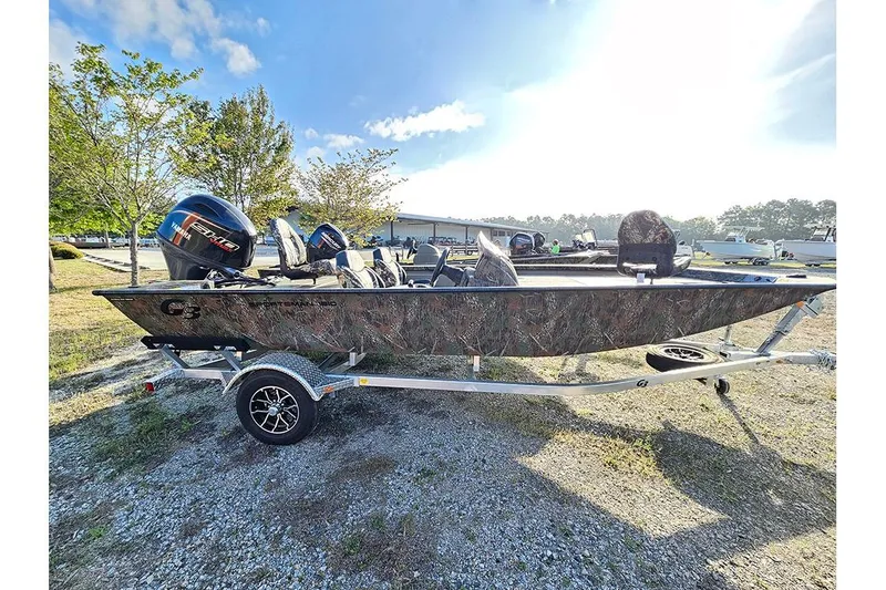 Slide: The Image of 2026 G3 Sportsman 1810 boat on trailer, camo design, parked outdoors. - 4