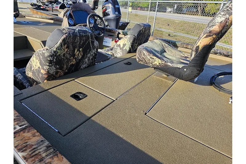 Slide: The Image of 2026 G3 Sportsman 1810 boat interior with camouflage seats and storage compartments. - 7