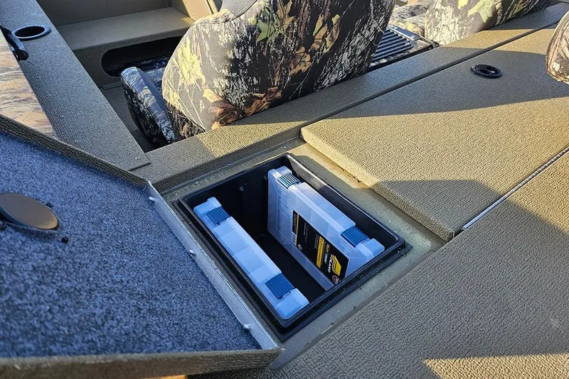 Slide: The Image of 2026 G3 Sportsman 1810 boat interior with camo seats and storage compartment. - 8