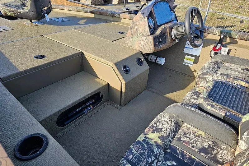 Slide: The Image of 2026 G3 Sportsman 1810 boat interior with camouflage seats and steering console. - 9