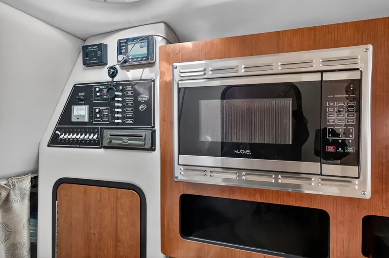 Slide: The Image of Interior of 2019 Crownline 264 CR with microwave and control panel. - 10