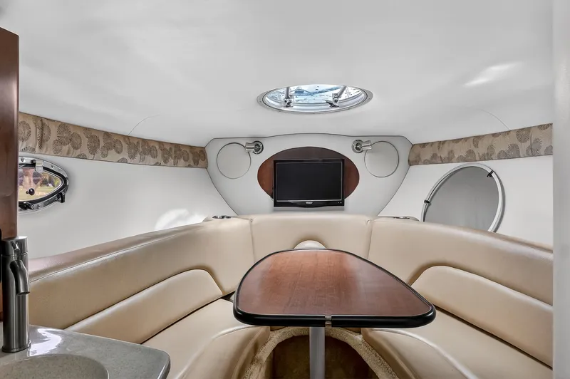 Slide: The Image of Interior of 2019 Crownline 264 CR with table and TV. - 12