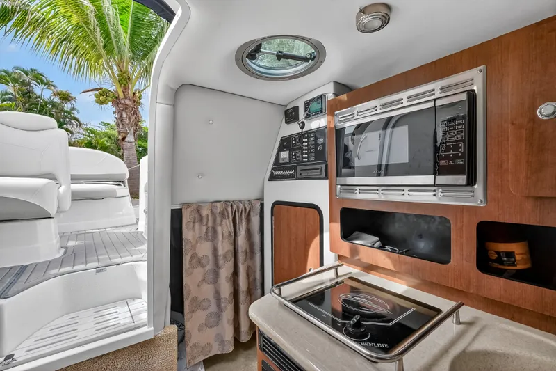 Slide: The Image of Interior of 2019 Crownline 264 CR with kitchen and controls. - 15