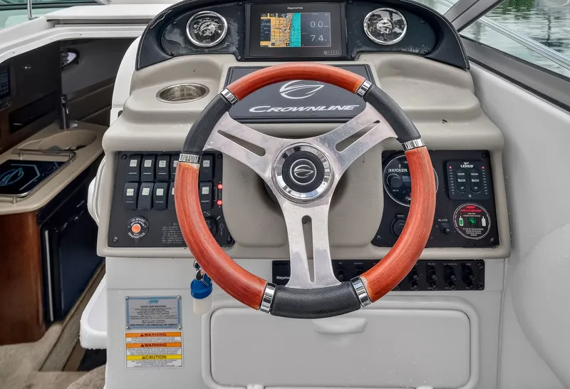 Slide: The Image of Steering wheel and dashboard of the 2019 Crownline 264 CR. - 16