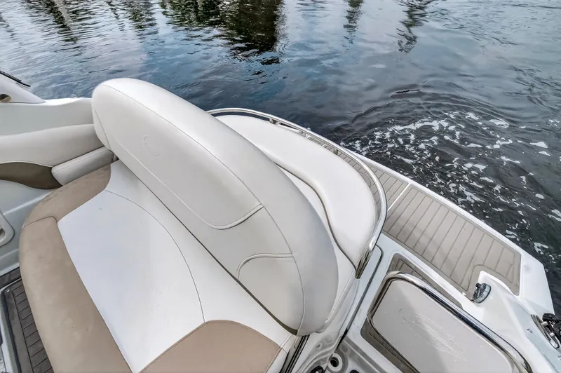 Slide: The Image of Crownline 264 CR 2019 boat with white seating by the water. - 22