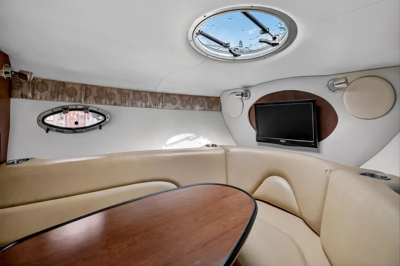 Slide: The Image of Interior of 2019 Crownline 264 CR with seating area and TV. - 5