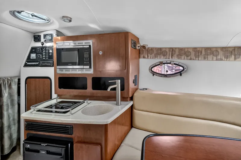 Slide: The Image of Interior of 2019 Crownline 264 CR with kitchen and seating area. - 6