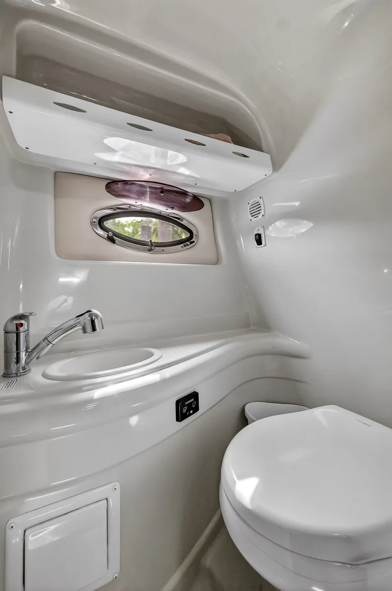 Slide: The Image of Interior of 2019 Crownline 264 CR with sink and toilet. - 7