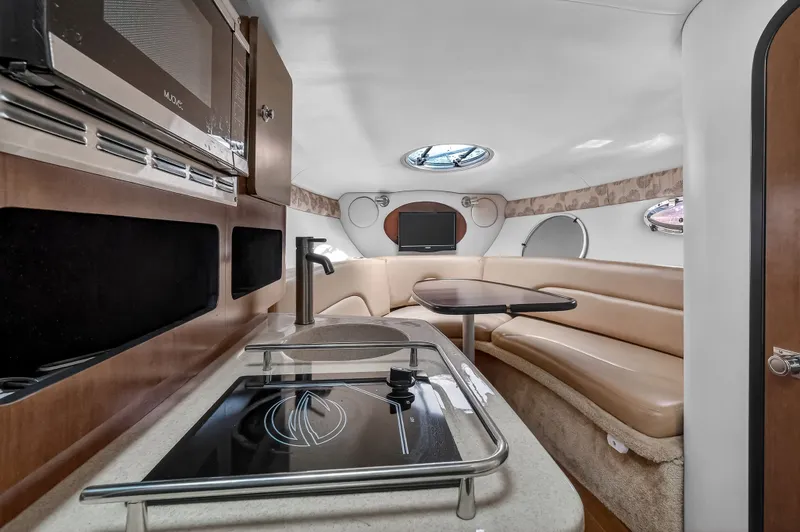 Slide: The Image of Interior of 2019 Crownline 264 CR with kitchenette and seating area. - 8