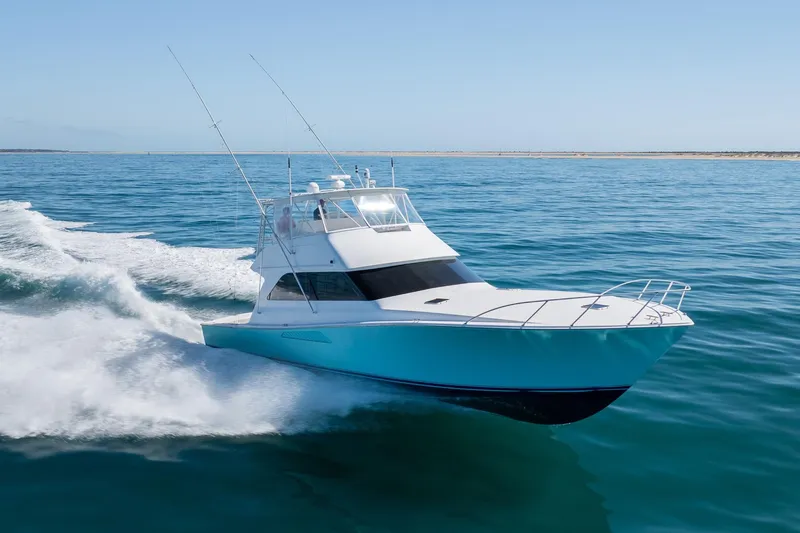 Slide: The Image of Viking 55 Convertible 2000 yacht cruising on open sea under clear blue sky. - 11