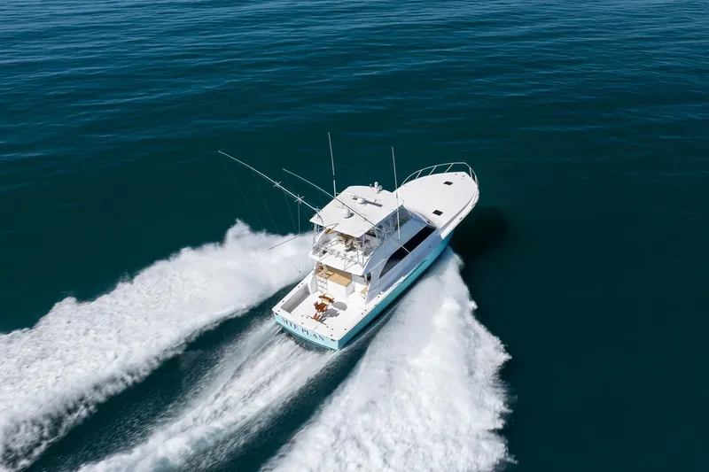 Slide: The Image of Aerial view of 2000 Viking 55 Convertible yacht cruising on open water. - 18