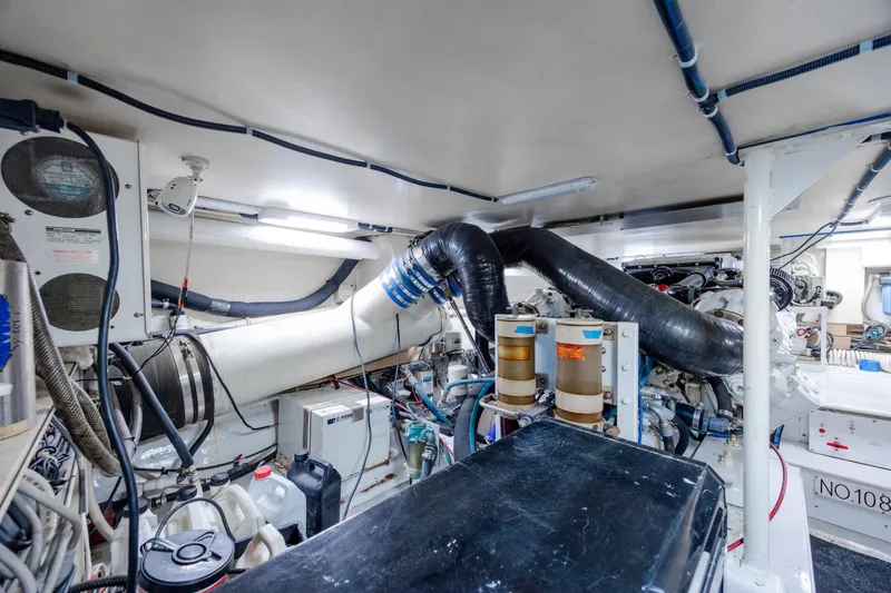 Slide: The Image of Engine room of a 2000 Viking 55 Convertible yacht, showcasing machinery and components. - 20