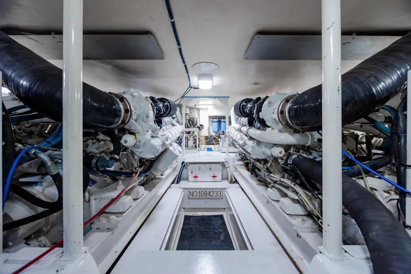 Slide: The Image of Engine room of a 2000 Viking 55 Convertible yacht, showcasing dual engines and mechanical systems. - 22