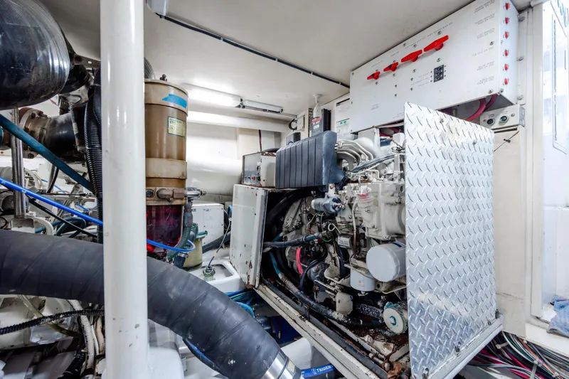 Slide: The Image of Engine room of 2000 Viking 55 Convertible yacht, showcasing machinery and control panels. - 23