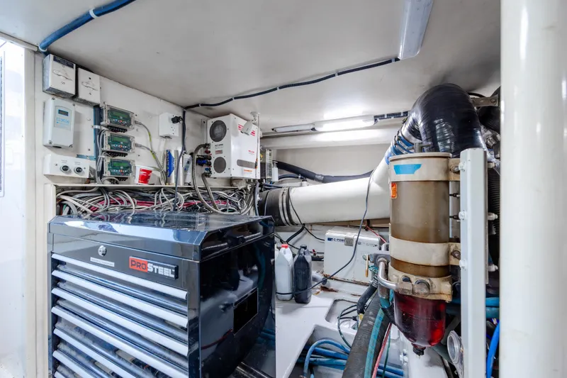 Slide: The Image of Engine room of 2000 Viking 55 Convertible yacht with tools and wiring. - 24