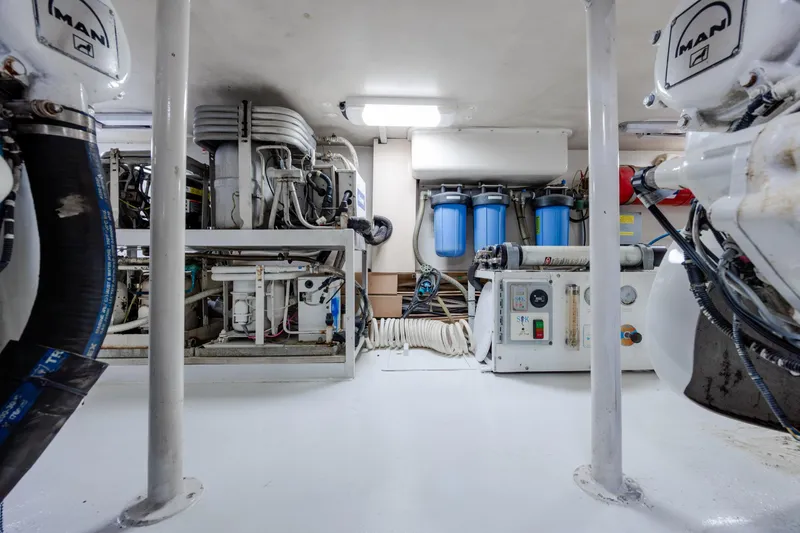 Slide: The Image of Engine room of a 2000 Viking 55 Convertible yacht, featuring MAN engines and filtration systems. - 25