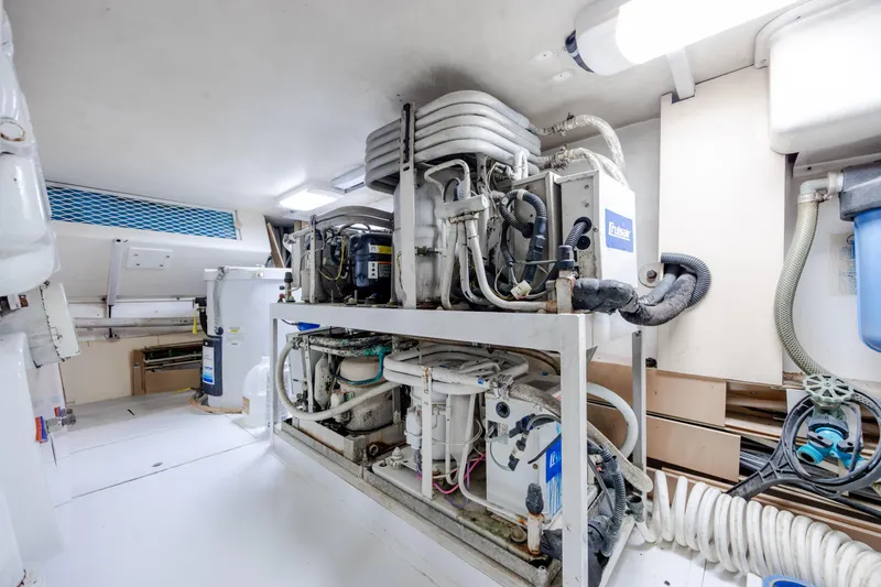 Slide: The Image of Engine room of a 2000 Viking 55 Convertible yacht, showcasing mechanical equipment and systems. - 26