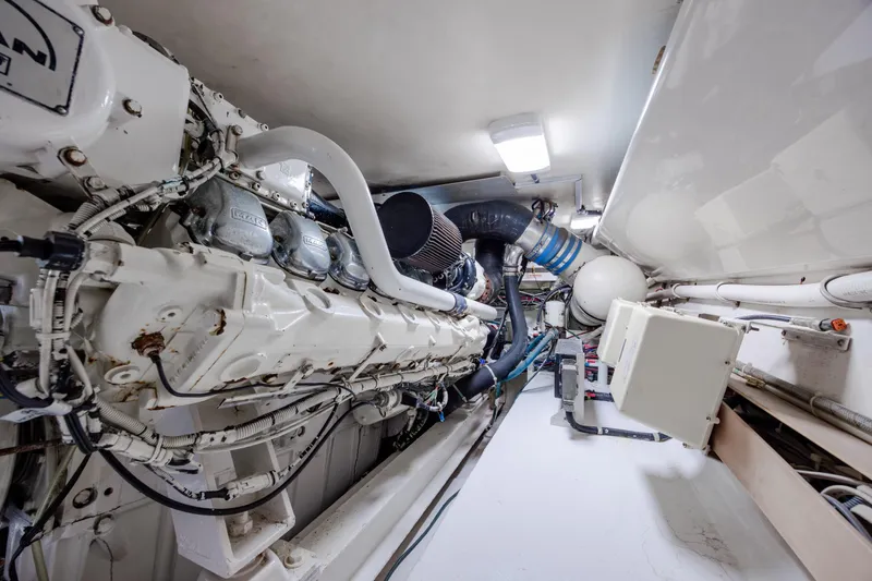 Slide: The Image of Engine room of a 2000 Viking 55 Convertible yacht, showcasing machinery and components. - 29