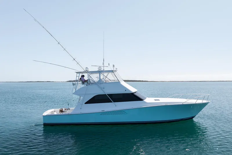 Slide: The Image of 2000 Viking 55 Convertible yacht cruising on calm blue waters. - 3