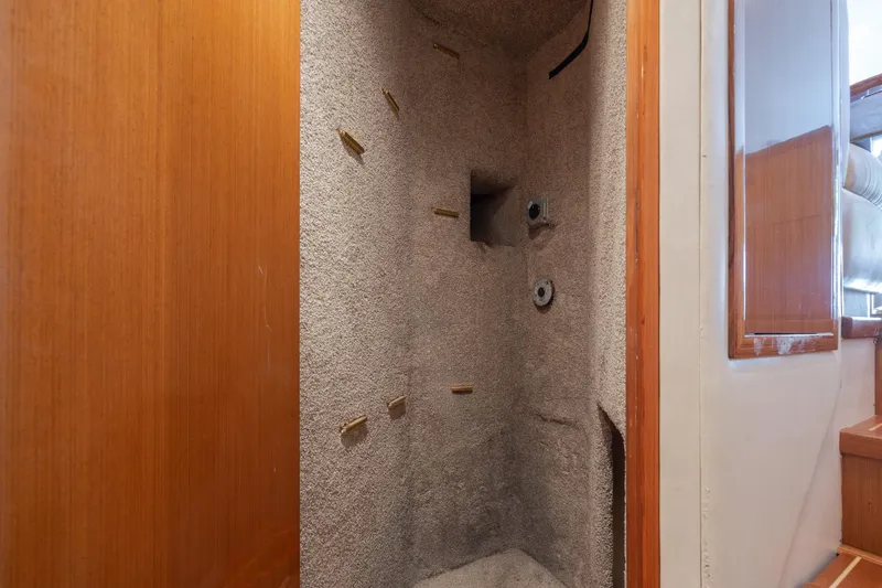 Slide: The Image of Interior view of a 2000 Viking 55 Convertible yacht, featuring a carpeted storage area. - 33