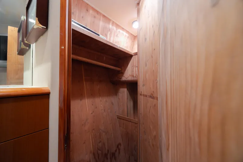 Slide: The Image of Wood-paneled interior of 2000 Viking 55 Convertible yacht, featuring shelves and cabinetry. - 37