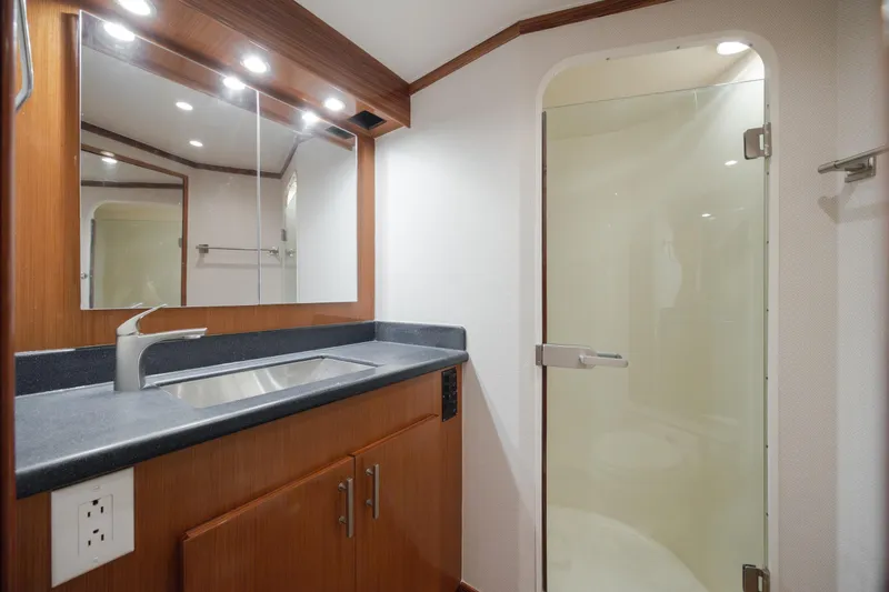 Slide: The Image of Luxurious bathroom in 2000 Viking 55 Convertible yacht with modern fixtures and glass shower. - 43