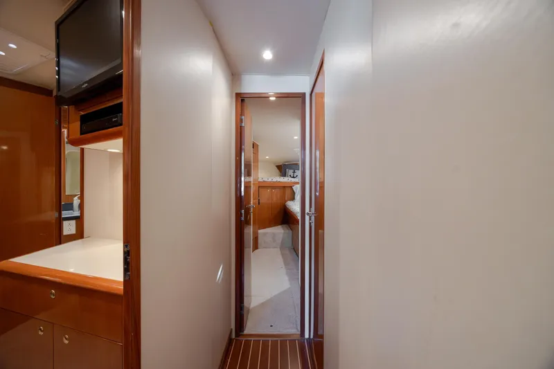 Slide: The Image of Interior hallway of 2000 Viking 55 Convertible yacht, featuring wood accents and modern amenities. - 47