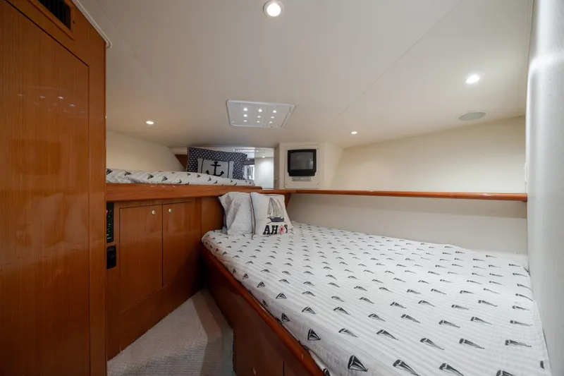 Slide: The Image of Cozy cabin interior of 2000 Viking 55 Convertible yacht with nautical-themed bedding. - 48