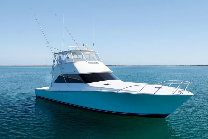 Slide: The Image of 2000 Viking 55 Convertible yacht on calm blue waters under clear sky. - 5