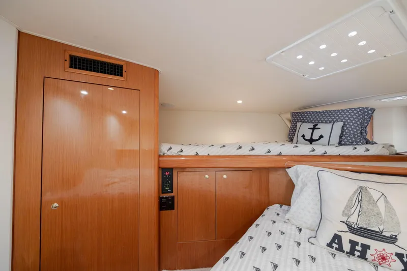 Slide: The Image of Interior cabin of 2000 Viking 55 Convertible yacht with nautical-themed bedding. - 50