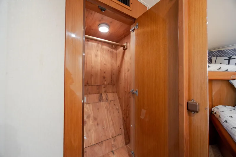 Slide: The Image of Wooden closet interior on a 2000 Viking 55 Convertible yacht. - 51