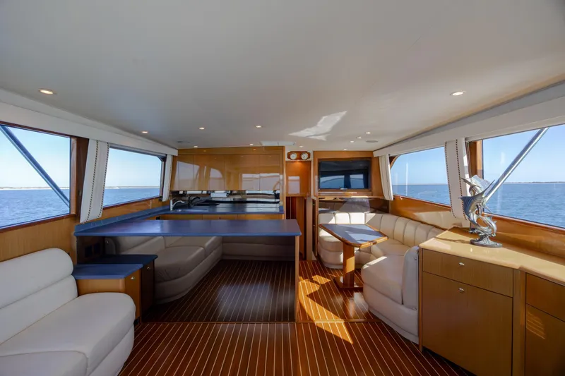 Slide: The Image of Luxurious interior of a 2000 Viking 55 Convertible yacht with elegant seating and ocean views. - 55