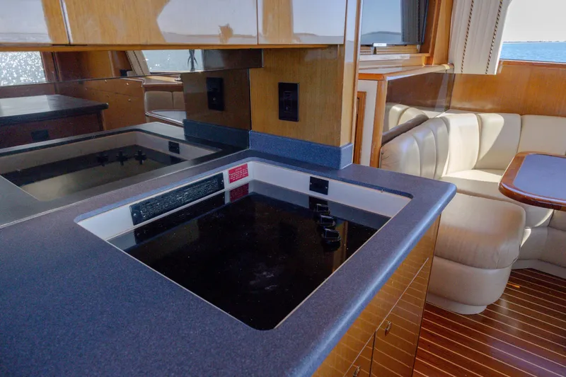 Slide: The Image of Interior of 2000 Viking 55 Convertible yacht with modern kitchen and seating area. - 59