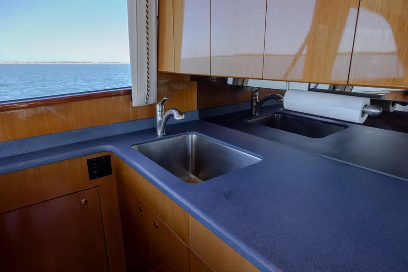 Slide: The Image of Kitchen area of a 2000 Viking 55 Convertible yacht with ocean view. - 60