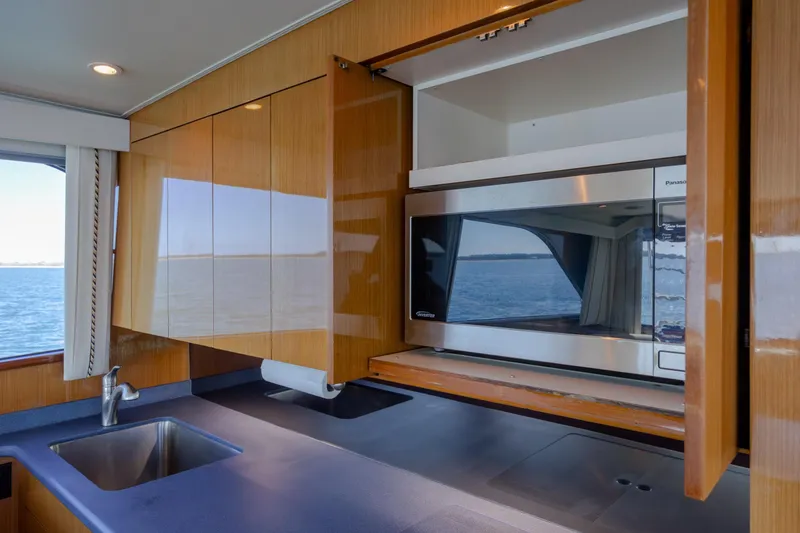 Slide: The Image of Modern kitchen interior on a 2000 Viking 55 Convertible yacht with ocean view. - 61