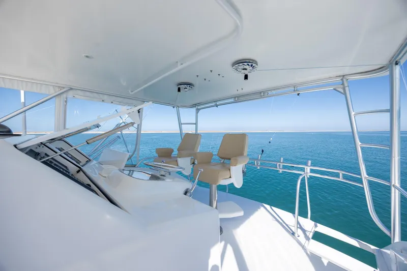 Slide: The Image of Flybridge of 2000 Viking 55 Convertible yacht with ocean view and helm chairs. - 71