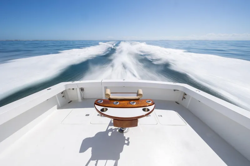 Slide: The Image of Viking 55 Convertible 2000 yacht cruising on open water, leaving a wake behind. - 78