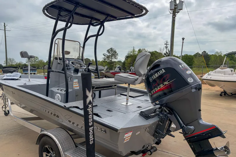 Slide: The Image of 2024 Xpress H190 boat with Yamaha engine, displayed outdoors on a trailer. - 10