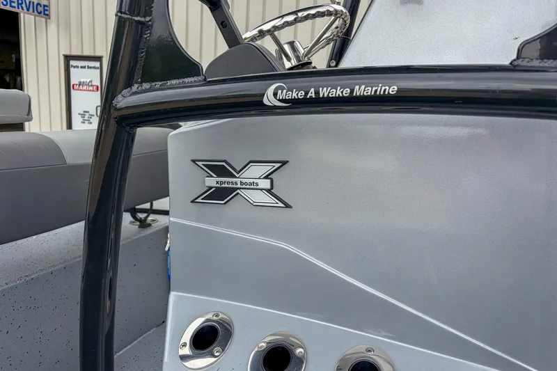 Slide: The Image of 2024 Xpress H190 boat dashboard with logo and steering wheel detail. - 4