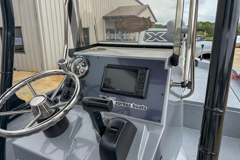 Slide: The Image of 2024 Xpress H190 boat dashboard with steering wheel and navigation display. - 6