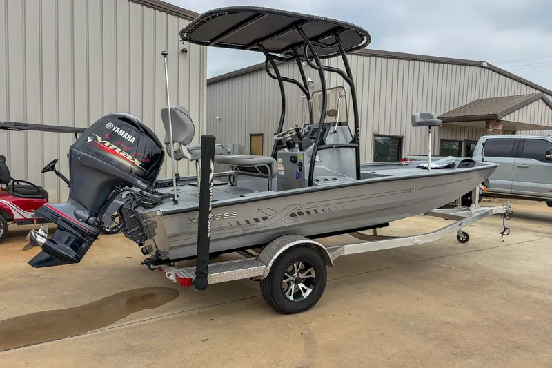 Slide: The Image of 2024 Xpress H190 boat with Yamaha engine on trailer, parked outside a building. - 8