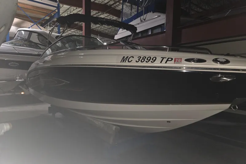 The Image of 2006 Chaparral 236 SSi boat in indoor storage, side view with registration number visible. - 0