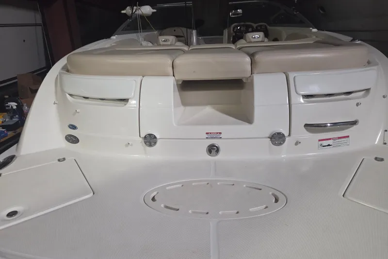 Slide: The Image of 2006 Chaparral 236 SSi boat interior with beige seating and white deck. - 1