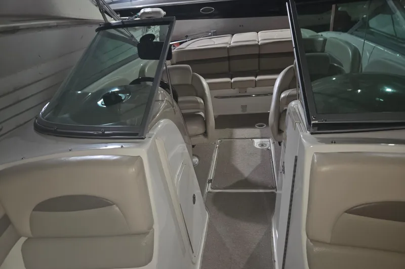 Slide: The Image of 2006 Chaparral 236 SSi boat interior with beige seating and open cockpit. - 10