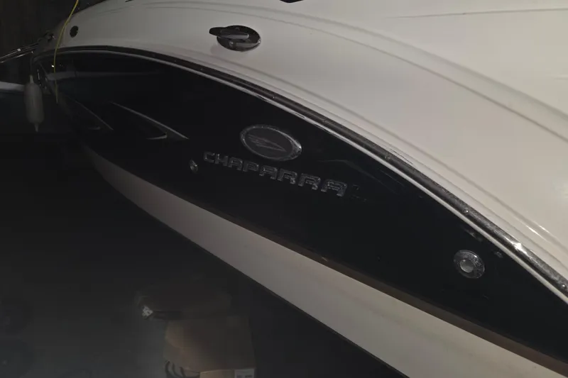 Slide: The Image of 2006 Chaparral 236 SSi boat side view with logo in dim lighting. - 16