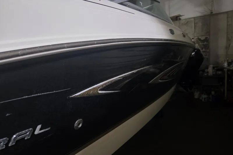 Slide: The Image of 2006 Chaparral 236 SSi boat in a dimly lit garage, showcasing sleek design. - 17