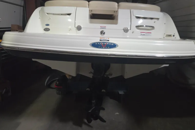 Slide: The Image of Rear view of a 2006 Chaparral 236 SSi boat in a garage setting. - 2
